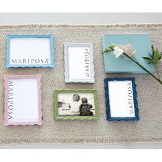 four different frames with flowers in them sitting on the floor next to each other,