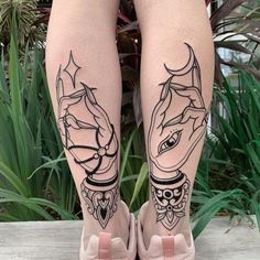 a woman's legs with tattoos on them