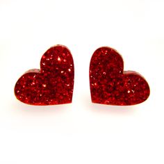 A little glam goes a long way with these Red Glitter Heart Stud Earrings! ♥ Little Heart Pendants are made of laser cut red glitter acrylic. ♥ Each Heart measures .5″ across. ♥ Pick which Stud Post these are made with! -Nickel Free Posts -Stainless Steel -Plastic Posts -Clip Ons -Titanium Posts ♥ Makes a loving Valentine's Day Gift or any day Gift! Comes in a cute little gift box. Minimalistic, yet a bold statement of love and glitter. 💖 -------◆-◆-◆------- Join the ★Email★ List and get a Sign Red Glitter Earrings For Gift, Glitter Red Earrings For Gifts, Red Glitter Earrings For Party, Valentine's Day Sparkling Heart Earrings For Party, Red Glitter Party Earrings, Red Glitter Jewelry For Party, Glitter Earrings For Valentine's Day Party, Romance Gifts, Cosplay Jewelry