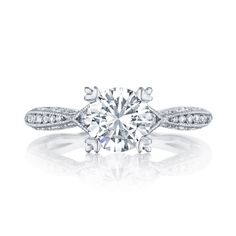 a diamond engagement ring with an intricate band around the center and side stones on top