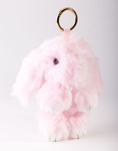 a pink stuffed animal keychain with a gold ring around it's neck