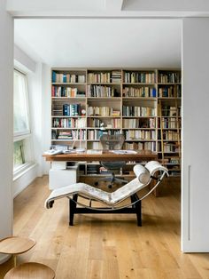 an office with bookshelves, desk and chair