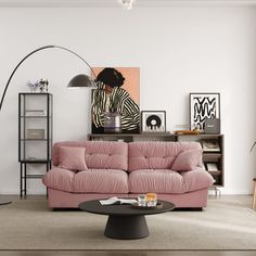 a living room with pink couches and pictures on the wall above it, along with a black coffee table