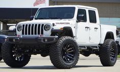 a white jeep parked in front of a building