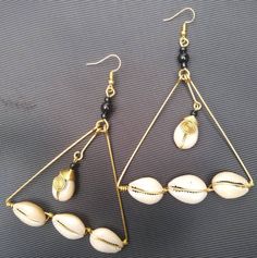 The earrings are  made with a lot of love and care from cowries and brass.   The wire is coiled to give a stunning look.  The are  beautifully designed for you, sister, mother, relative or a friend. The are light in weight and comfortable to wear. **This listing is for one pair of earrings.** Buy multiple items pay shipping for one the rest ships free. Custom orders are welcome. For more earrings, follow the link. https://www.etsy.com/listing/697317594/african-earrings-gift-for-her-earrings?ref=related-1 **Happy shopping** Dhl shipping express Thank you. Handmade Metal Dangle Wrap Earrings, Traditional Nickel-free Earrings For Beach, Wire Wrapped Drop Earrings For Beach, Beach Wire Wrapped Teardrop Earrings, Beach Teardrop Wire Wrapped Earrings, Beaded Brass Drop Earrings, Beach Dangle Earrings Wire Wrapped, Brass Beaded Drop Earrings, Handmade Gold Hoop Earrings For Beach