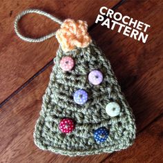 a crocheted christmas tree ornament with buttons