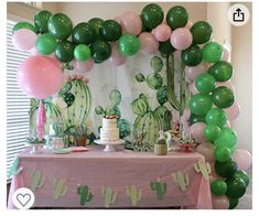 a table topped with green and pink balloons next to a cactus themed dessert bar area