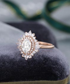 a diamond ring sitting on top of a velvet cushion