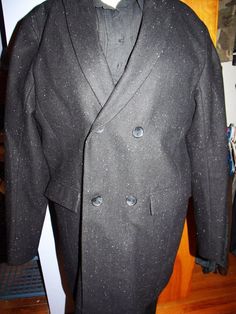 This is a very sharp Calvin Klein Peacoat. It looks new. Two inside pockets that button. The lining is 100% Polyester. There are two outer pockets. It is double breasted, with two buttons on each side. It is black with speckled beads of color sewn in.  Shoulder: 19" Pit: 23" Length: 36" Sleeve: 20" Semi-formal Fitted Double-breasted Wool Coat, Fitted Wool Coat With Double-breasted Button And Notch Lapel, Fitted Wool Coat With Notch Lapel And Double-breasted Buttons, Winter Double-breasted Suits With Button Closure, Formal Fitted Tweed Wool Coat, Fitted Double-breasted Wool Coat With Hidden Buttons, Fitted Tweed Wool Coat, Double-breasted Tweed Wool Coat For Formal, Double-breasted Tweed Wool Coat For Formal Occasions