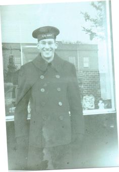 an old black and white photo of a man in uniform