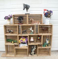 a wooden crate filled with lots of different types of figurines on top of it