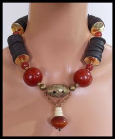 1 of a Kind!  Beautiful beads in this necklace Large, handmade @@ber @@sin beads from Morocco, hand carved off-round Carnelian beads, hand carved African coconut shell discs, handmade African brass beads, very old handmade tiny African clay beads and hand carved bone bead.  I have handforged brass domed discs to "encase" the coconut shell discs.   Necklace fastens with my signature, large, fancy handforged bronze clasp and soldered link brass chain. Length adjusts from about 20 - 22 inches. NOT Unique Orange Necklace With Polished Beads, Unique Orange Jewelry With Wooden Beads, Carnelian Necklaces With Large Beads, Unique Carnelian Necklaces With Large Beads, Brown Carnelian Beaded Jewelry, Unique Handmade Carnelian Beads, Brown Carnelian Beaded Necklace With Large Beads, Brown Carnelian Large Beaded Necklace, Unique Brown Necklace With Spacer Beads