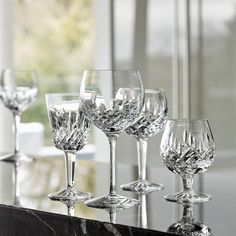 several wine glasses lined up on a table