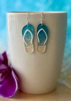 Super cute acrylic flip flop earrings.  Great for beach vacations or just a staycation!  Made of acrylic and hypoallergenic hardware.  Styles include: surf and sand, turquoise acrylic and rose gold acrylic.  These earrings can be made in 2 different sizes.  The larger size has a drop length of 2 inches.  The length of the actual flip flop is 1.5 inches and the width of a single flip flop is .625 inches at the widest part.  The smaller size has a drop length of 1.75 inches.  The length of the actual flip flop is 1.375 inches and the width of a single flip flop is .5 inches at the widest part.  Please specify if you would like the larger or smaller size in the personalization section. Earrings Beach, Summer Earrings, Beach Vacations, Summer Earring, Beach Jewelry, Flip Flop, Beach Vacation, Lighthouse, Jewelry Earrings Dangle