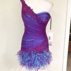 Enzoani Ruffled Teal Satin Underlay With Purple Netted Rushing Dress, One-Shoulder Statement Sleeve, And Corset Back Closure. Purple Blue Size 2 | Bust 15" Waist 13" Hips 18" Length 23" Mini To Knee-Length, Depending On Your Height New Condition With Tags. If You're Curious Yet Undecided, Ask For Additional Information And Pictures. Open To Offers. Sales Are Final. Capriciously, Tt Fri Rushing Dress, Enzoani Blue, Midi Formal Dress, Black Satin Mini Dress, Shoulder Ruffle Dress, One Shoulder Cocktail Dress, Chloe Dress, Rush Dresses, Black Leather Dresses