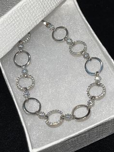 "Stunning women's or girl's iced out circle link bracelet Solid 925 sterling silver, rhodium finish to prevent tarnish Bracelets are adjustable from 7 to 8\" Iced out with high grade cz stones for an amazing shine! Weighs 8.2 grams 10mm wide Solid silver, will never turn your skin green. Contains no nickel or brass." Adjustable Round Diamond Bracelet, Round Chain Bracelet With Diamond Accents, Silver Cubic Zirconia Circle Jewelry, Silver Circle-shaped Cubic Zirconia Jewelry, Cubic Zirconia Jubilee Bracelet, Silver Cubic Zirconia Jewelry, White Gold Diamond Cut Chain Bracelet, Sterling Silver Chain Bracelet For Anniversary, Adjustable Sterling Silver Bracelet With Diamond Cut