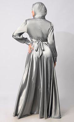 Introducing our exquisite Lycra Satin Flared Abaya, a stunning fusion of elegance and contemporary style. Crafted with meticulous attention to detail, this abaya is designed to elevate your modest fashion wardrobe to new heights. The flared silhouette adds a touch of graceful movement, enhancing the overall allure of the garment. Featuring a front draped pleated style, which adds texture and dimension, creating visual interest and a unique focal point. Complementing the pleats are satin show buttons, delicately embellishing the front of the abaya for a refined finish. For added versatility and cinched-in definition, an attached belt accompanies the abaya, allowing you to adjust the fit according to your preference and accentuate your waistline. The back zipper closure ensures a seamless an