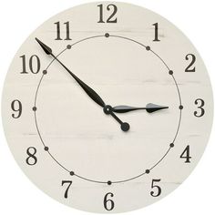 a white clock with black hands and numbers on the face is shown against a white background