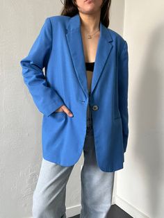 Classic blue single breasted blazer with a pointed notched collar, pockets, a blue lining, shoulder pads and a single mother-of-pearl center button closure. In excellent vintage condition. DETAILSLabel: DressbarnMaterial: 50% Polyester, 50% Rayon SIZE & MEASUREMENTSTag Size: 14Length: 32"Bust: 43"Waist: 44"Sleeve: 24"Shoulder: 18" Blue Semi-formal Blazer For Spring, Blue Semi-formal Spring Blazer, Blue Notch Lapel Blazer For Work, Blue Single-button Blazer For Work, Blue Notched Blazer For Work, Blue Single Button Blazer For Workwear, Blue Notched Blazer For Workwear, Notched Blue Blazer For Work, Blue Blazer With Suit Collar For Work