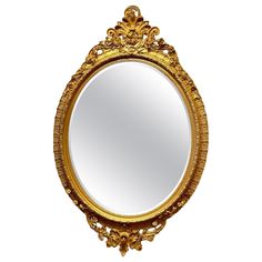 an ornate gold framed mirror on a white background