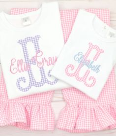 This sweet shirt & ruffle pant set is made from our bright pink gingham fabric & paired with a periwinkle blue embroidered name. Purple gingham pant set available too, please message us! Our white boutique bodysuits & shirts are the highest quality on the market. They are thick, soft & beautifully constructed. They run true to size. We recommend to size up if unsure. Our ruffle pants are made from beautiful, high quality, floral printed fabric. They have an elastic waistband &amp Pink Monogrammed Cotton Top, Pink Monogram Cotton Top, Spring Family Matching Pink Sets, Family Matching Pink Sets For Spring, Pink Top For First Birthday In Spring, Pink Tops For First Birthday In Spring, Personalized Pink Tops For Spring, Personalized Pink Top For Spring, Personalized Fitted Pink Tops