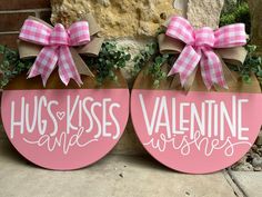 two wooden signs with pink bows on them that say hugs kisses and valentine wishes