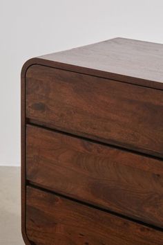 a close up of a wooden drawer on a white surface with no one around it