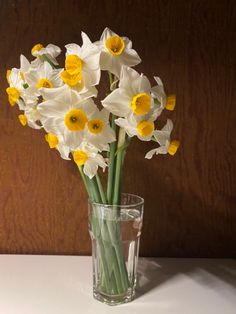 white and yellow flowers in a glass vase