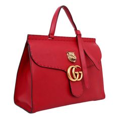 This limited edition Gucci GG Marmont Top Handle Bag is from the coveted Animalier collection. This once-in-a-lifetime bag is a classic luxury handbag that is a beautiful addition to any designer handbag lovers closet. This stunning Gucci Marmont Bag is crafted from red leather, features flat handle with knot on one end, flap top with GG logo and animalier dietail on top, tonal stitching detail, and aged gold-tone hardware. Its push-lock closure opens to a beige canvas interior with zip and slip Designer Handheld Satchel With Top Carry Handle, Designer Handheld Bags With Gold-tone Hardware, Designer Satchel With Gold-tone Hardware For Daily Use, Luxury Top Handle Bags For Daily Use, Luxury Satchel With Detachable Handle For Daily Use, Luxury Handheld Bag With Top Carry Handle, Designer Satchel With Branded Hardware, High-end Satchel Tote With Branded Hardware, Designer Handheld Bag With Branded Hardware