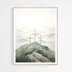 three crosses on top of a mountain with fog