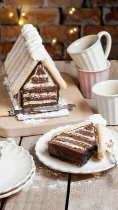 a slice of cake sitting on top of a white plate next to a cup and saucer