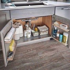 an open cabinet in the middle of a kitchen