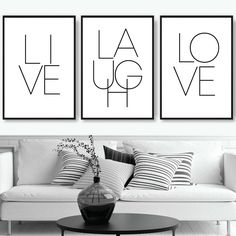 three black and white art prints on the wall above a couch in a living room