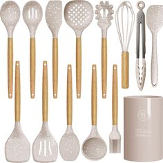 the kitchen utensils are lined up next to each other, including spatulas and spoons