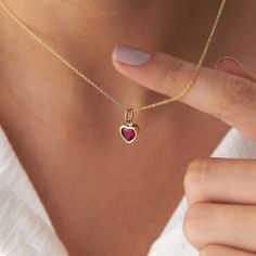 This elegant red heart necklace is crafted with 14k solid gold, embodying timeless beauty and sophistication. Its minimalist design, combined with the finest craftsmanship, makes it a perfect piece for everyday wear or a meaningful gift for a loved one. This necklace is crafted with real 14k solid gold(not plated, not vermeil, not gold filled) You don't need to worry about water, perfume or conditioner contact since real gold doesn't tarnish. The center features a heart cut red cubic zirconia, meticulously bezel set into the gold frame. Heart Gem Stone Necklace, Luxury Red Oval Pendant Jewelry, Red Heart Pendant Necklace, Heart Stone Necklace, Red Heart Pendant, Galaxy Stuff, Red Heart Necklace, Mesmerizing Beauty, Jewel Necklace