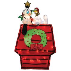 two stuffed animals sitting on top of a christmas present bag with lights around the neck