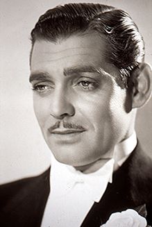 a black and white photo of a man in a tuxedo