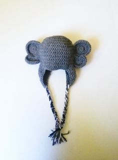 a crocheted elephant hat hanging on the wall