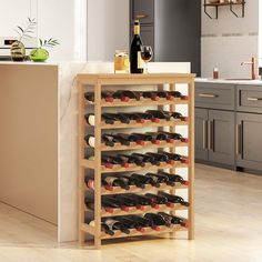 a wine rack in the middle of a kitchen with many bottles on top of it