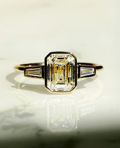 an emerald and baguette cut diamond ring