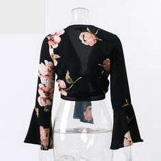 This sexy & sassy floral cropped top is sheer perfection. Made with a cotton & polyester blend and featuring a plunging v-neckline, a tie-up front and flare sleeves this top pairs perfectly with pants, skirts, shorts, jeans or leggings. Flare Sleeves, Shorts Jeans, Cropped Top, Flared Sleeves, Black Floral, Bell Sleeve Top, Leggings, Crop Tops, Boutique