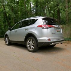 the back end of a silver car parked in a driveway