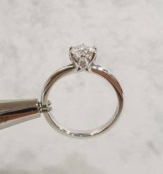 a close up of a ring with a diamond on it