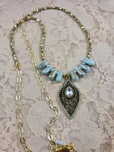 This elegant statement necklace makes a nice gift for a birthday, anniversary, the holidays or for any special occasion or for a night out on the town! It can be worn all year round. It is designed with pale turquoise and gold glass teardrop beads, gold shiny metal beads, a gold chain and lobster claw clasp, and a color coordinated pale turquoise, crystal and gold plated teardrop pendant. The drop length is 14 inches.  If you look through my earring and bracelet collection you should be able to find pieces designed with the same beads to create a matching jewelry set if they are still available. Bohemian Metal Necklaces With Faceted Beads, Bohemian Necklace With Faceted Metal Beads, Bohemian Metal Necklace With Faceted Beads, Bohemian Gold Dangle Crystal Necklaces, Bohemian Teardrop Necklace For Weddings, Teardrop Adjustable Chain Necklace For Party, Teardrop Necklace With Adjustable Chain For Party, Gold Crystal Necklaces With Faceted Beads For Party, Bohemian Jeweled Dangle Necklaces