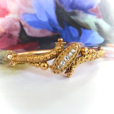 "What a rare find in excellent condition from the romantic Victorian period! A staple antique treasure that can be worn with anything! This bracelet is made in 14k yellow gold and is in the gorgeous and true Etruscan Revival style with beautiful gold adornments and glittering antique cut diamonds for a transcendent style you will absolutely love. Don't miss this 14k yellow gold and diamond bracelet, of hand-made construction, circa late 19th century. The hinged bracelet measures 6\" inside (will Bracelets Gold Diamond, Hinged Bracelet, European Cut Diamonds, Antique Victorian, Unique Rings, Handmade Bracelets, Amazing Jewelry, Bracelet Making, Cuff Bracelet