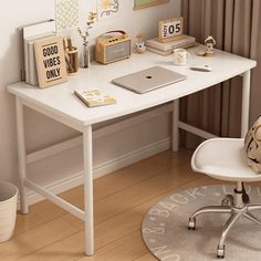 a white desk with a laptop computer on top of it next to a chair and potted plant