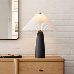 a table lamp sitting on top of a wooden dresser