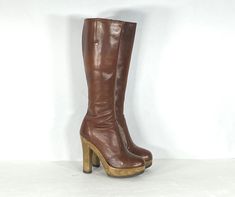 "1970s elegant brown leather platform boots by the popular maker, Sbicca. Have a tall shaft and unique molded and shaped plastic platform heels. The leather fits close to the leg in a dress boot style. Has almond toes, interior zipper, and gussets for fit. Comes with the original box. Condition: excellent vintage condition. Label: Sbicca / 5.5 Circa: 1970s Composition: leather upper, plastic heel, rubber sole Color: brown Size: 5.5 Fits like a: 5.5 (US) 36 (eu) 3 (uk) Measurements: Length of ins Stevie Nicks Boots Platform, Retro Brown Leather Platform Boots, Retro Knee-high Platform Boots, Retro Brown High Heel Platform Boots, Retro Brown Platform Boots With Round Toe, Brown Retro High Heel Platform Boots, Retro Brown Platform Boots For Fall, Vintage Brown Platform Boots With Round Toe, Vintage High Heel Platform Boots For Fall