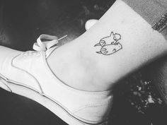 a woman's foot with a small tattoo on the side of her left ankle