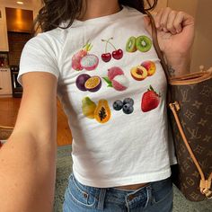 Fruit Baby Tee: SHIRT (Fruit of the Loom 3930BR): - Lightweight to mediumweight tee perfect for a hot and humid climate - 5 oz./yd², pre-shrunk 100% cotton - Garment weight: 5 oz/yd² (midweight) - High-density fabric knit for great print quality - Seamless 1x1 ribbed collar - Shoulder-to-shoulder taping for better shoulder fit - Double-needle stitched sleeves, bottom hem and front neck for wash durability - Tear away label tag PRINT: Our shirts are printed with Direct-To-Garment printing, which Fruit Print Outfit, Fruit T Shirt, Fruit Clothes, Baby Tees 90s, Fruit Baby, Cherry Strawberry, Fruit Shirt, Y2k Baby Tee, Vegan Shirt